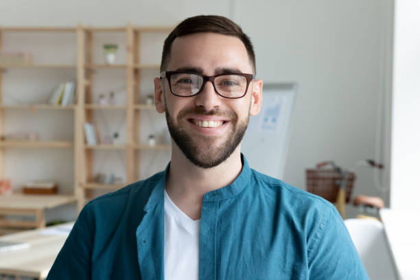 istockphoto-1309328823-612×612 Close up headshot portrait of smiling young Caucasian businessman in glasses posing in office. Profile picture of happy millennial male employee or worker in eyewear at workplace. Employment concept.